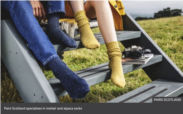 couple in landrover car on green field wearing mohair socks close up