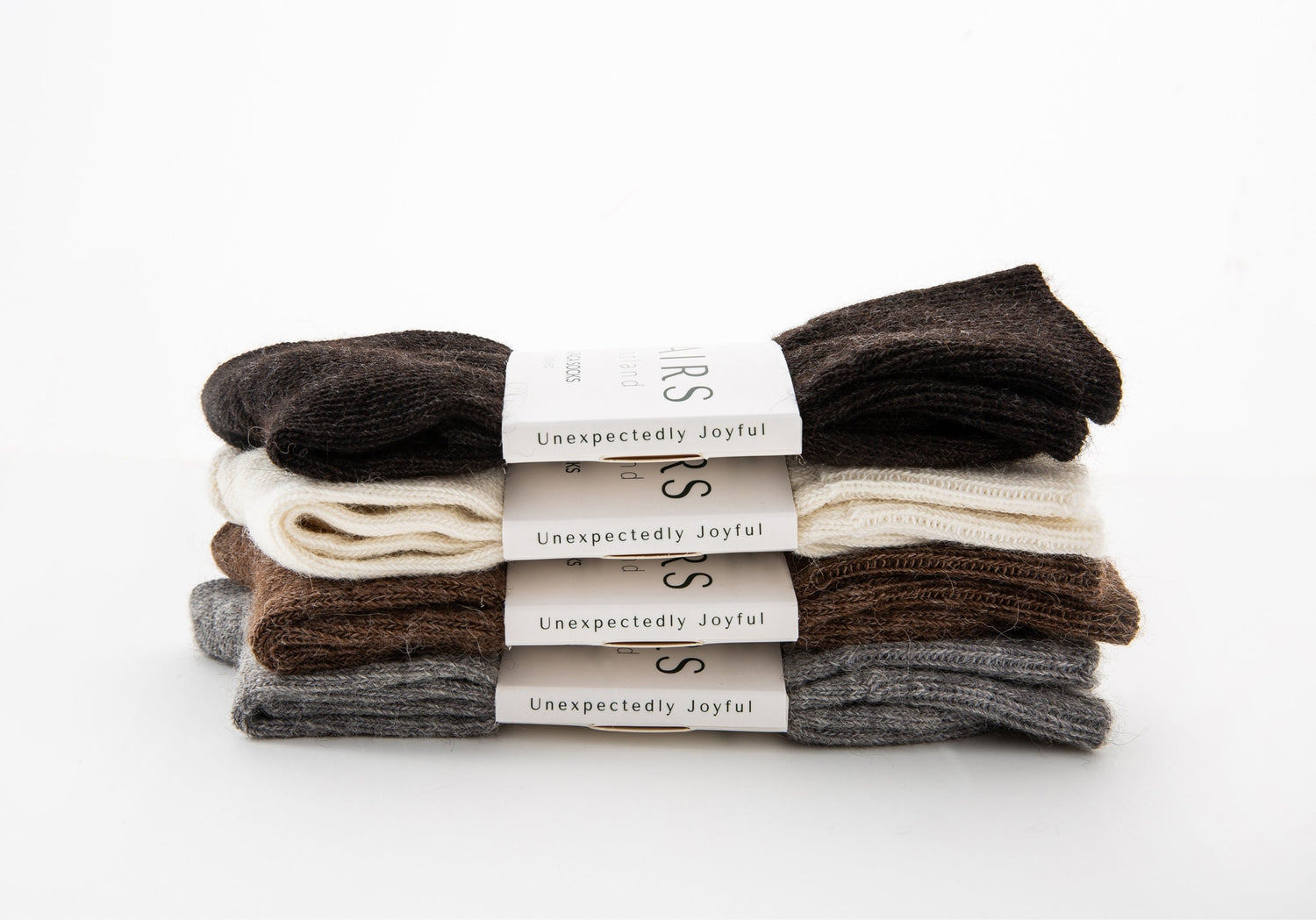 sustainable natural undyed alpaca wool socks product collection, four pairs piled up