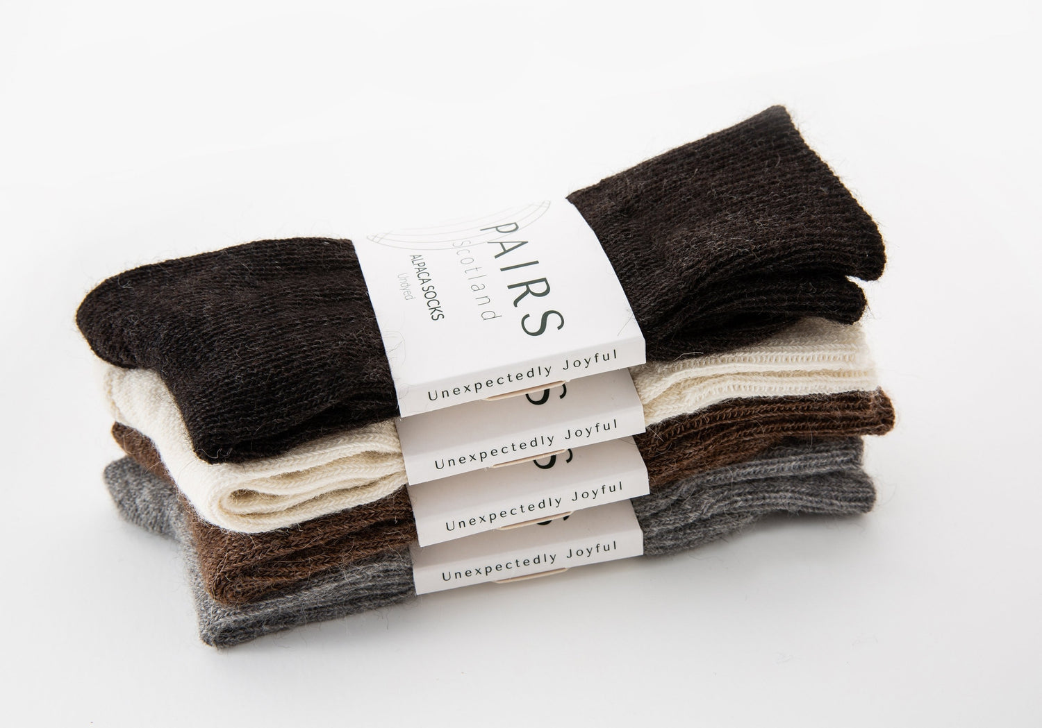 sustainable natural undyed alpaca wool socks product collection, four pairs piled up