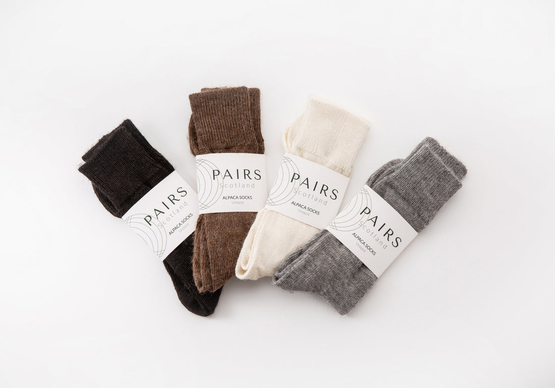 sustainable natural undyed alpaca wool socks product collection, four pairs piled up