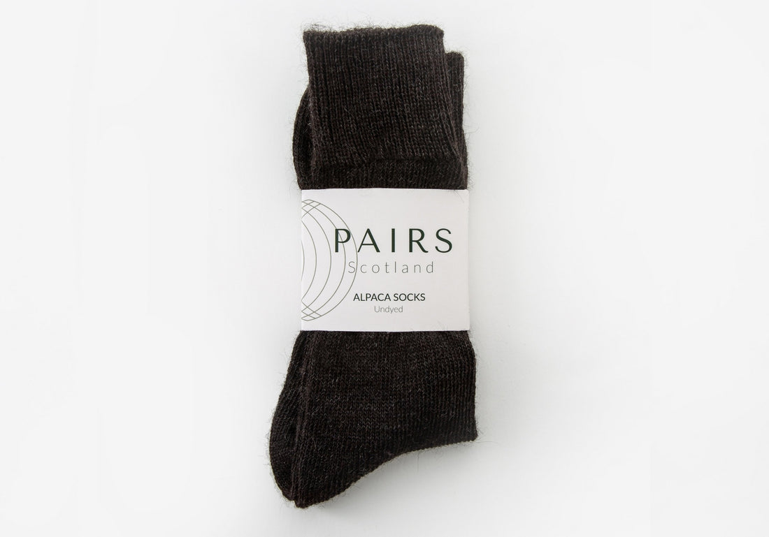 natural undyed black charcoal alpaca wool socks in brand packaging